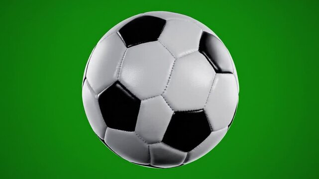 A classic soccer ball on a solid green background, showing black and white pentagons