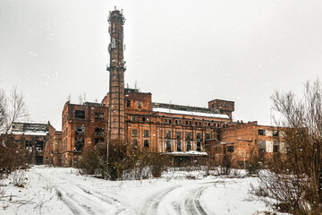 Old ruins of abandoned factory in snowy day