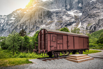 Old train car wagon under huge rock mount near Trollveggen
