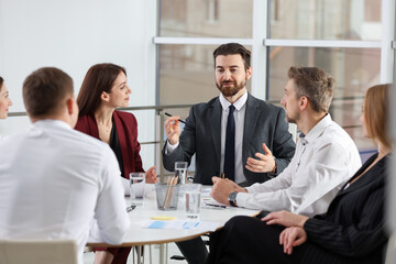 Businesspeople working together at table in office
