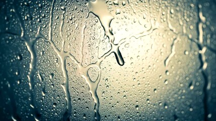 Rainy Window with Water Droplets and Light.