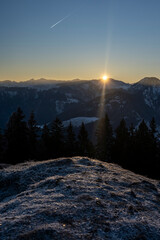 sunrise in the mountains in winter above the summits of Bregenzerwald in Vorarlberg Austria on a clear frosty morning 