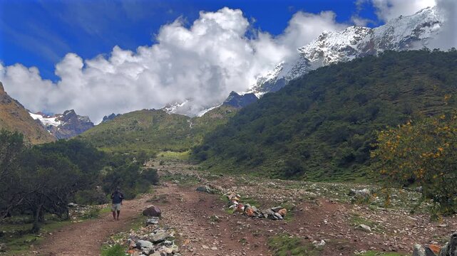 Peruvian Andes Humantay Laguna Lake Trek trail hike hiking down Peru Per&uacute; Salkantay glacier high altitude prominent peaks morning blue sky clouds sunny Anta province dry rainy season static shot