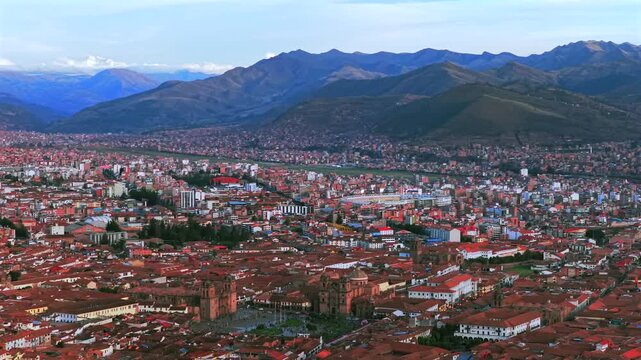 Cusco Cuzco Alejandro Velasco Astete International Airport Peru Per&uacute; cityscape red buildings Peruvian Andes landscape aerial drone rainy season sunny sunset clouds Inca Empire capitol pan left