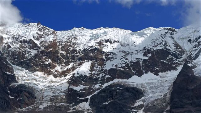 Peruvian Andes Mount Humantay Laguna Lake Peru Per&uacute; Salkantay high altitude prominent snow capped glacier peaks morning blue sky clouds fog sunny Anta province dry rainy season pan left