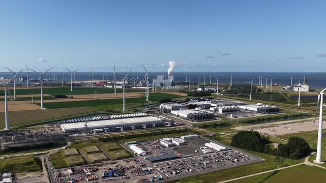 Daytime summer aerial drone video of a large-scale data center in the Eemshaven, The Netherlands, modern computing infrastructure, cloud technology, and high capacity digital processing facilities.