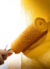 Painting a house wall with roller