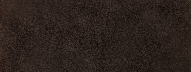 Dark brown suede fabric background with matte velvet texture, chocolate tones and soft felt surface in macro