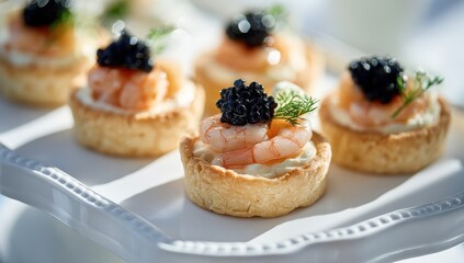 Exquisite Shrimp and Black Caviar Tartlets with Dill Garnish, Elegantly Arranged for Gourmet Appetizers.