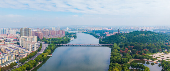 China Linqu ancient tower and urban garden architecture river landscape © guoquan