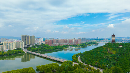 China Linqu ancient tower and urban garden architecture river landscape © guoquan