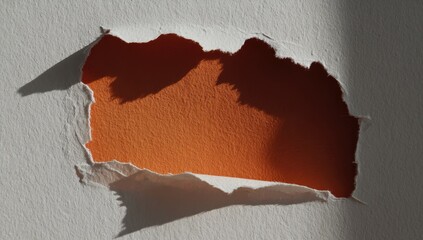 Ripped paper hole on orange background