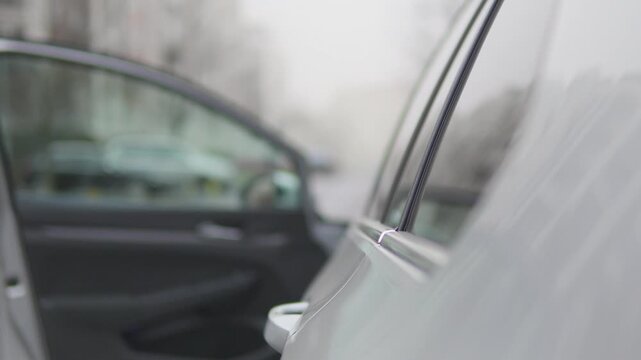 A man gets into a car - focused