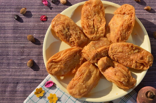 Khaja a deep- fried pastry that is often soaked in sugar syrup or filled with fruits. It is a popular sweet in Odisha India.