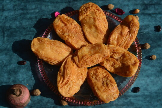 Khaja a deep- fried pastry that is often soaked in sugar syrup or filled with fruits. It is a popular sweet in Odisha India.