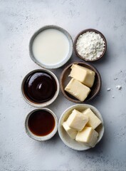 Culinary ingredients arranged on a light surface