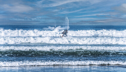 Jet Ski Rider Creating Dramatic Splash on Ocean Waves Under Clear Blue Sky, Agadir Morocco