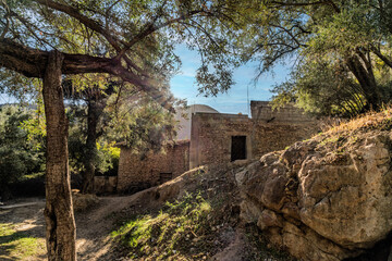 Sunlit Rustic Stone House Hidden Among Trees and Rocks in a Quiet Forest, Tizguan, Morocco