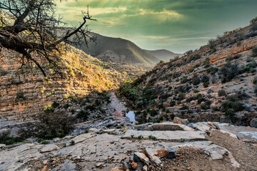 Serene Rocky Canyon Oasis With Pool, Trees, and Mountain Backdrop Under Blue Sky, Tizguan, Agadir, Morocco