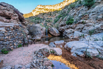 Serene Rocky Canyon Oasis With Pool, Trees, and Mountain Backdrop Under Blue Sky, Tizguan, Agadir, Morocco