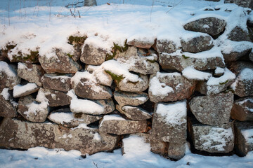 section of old snowy stone wall outdoors