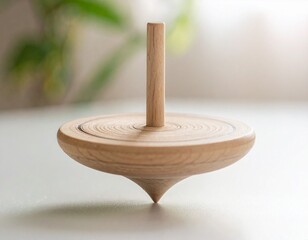 Wooden spinning top close up isolated on a white surface with soft lighting