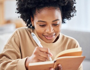 Woman writing in a notebook indoors with natural lighting and soft colors