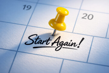 Concept of fresh start again to reset life goal planning on calendar page with yellow push pin marking important day