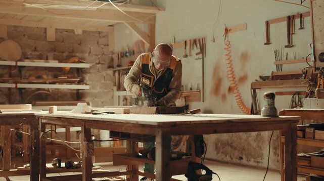 Wood, sander and carpenter in workshop with tools for furniture, production or construction project.