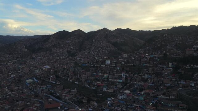 Mountainside homes Cusco Per&uacute; aerial drone Cuzco Saqsaywaman cityscape red buildings Peruvian Andes Plaza de Armas vive en Peru landscape rainy season daytime sunset Inca Empire capitol forward upward
