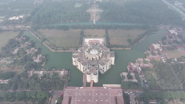 Aerial view of the Baitul Mukarram Mosque surrounded by a body of water and a huge gathering of people, Dhaka, Bangladesh.