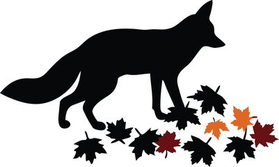 Elegant black silhouette of a wild fox standing among colorful autumn leaves on the ground