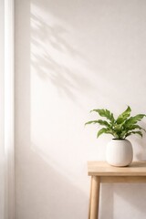 Minimalist interior scene featuring a vibrant green fern in a white ribbed ceramic vase, placed on a light wood console table against a neutral beige wall with soft window shadows.