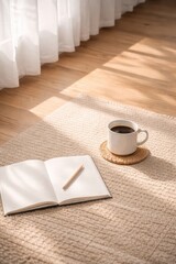 Cozy morning scene with a white coffee mug on a woven coaster and an open blank notebook with a wooden pencil, placed on a beige textured rug in a sunlit room with soft shadows.