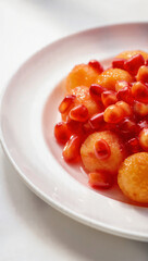 Fresh healthy tomato and onion salad with red cherry tomatoes in a white bowl served as a delicious vegetable meal garnished with green basil