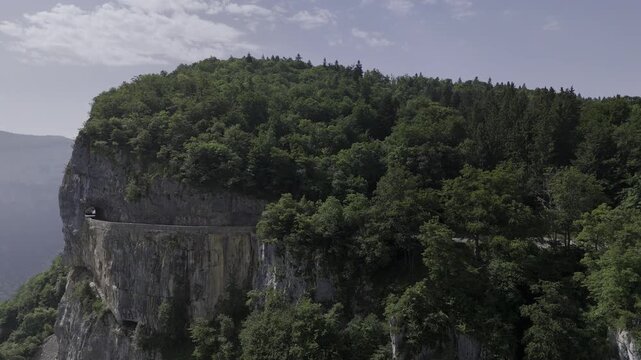 Combe Laval balcony road carved into cliffs in Vercors France. A winding scenic drive with stunning views ideal for motorcycle touring and camper van travel ads.