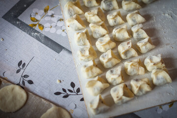 Polish Christmas dumplings artfully arranged on a wooden board, showcasing traditional cooking in a cozy kitchen