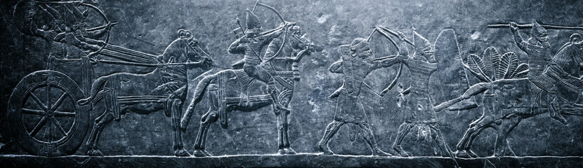 Assyrian relief on the wall. Historical and culturical background on the theme of civilizations of...