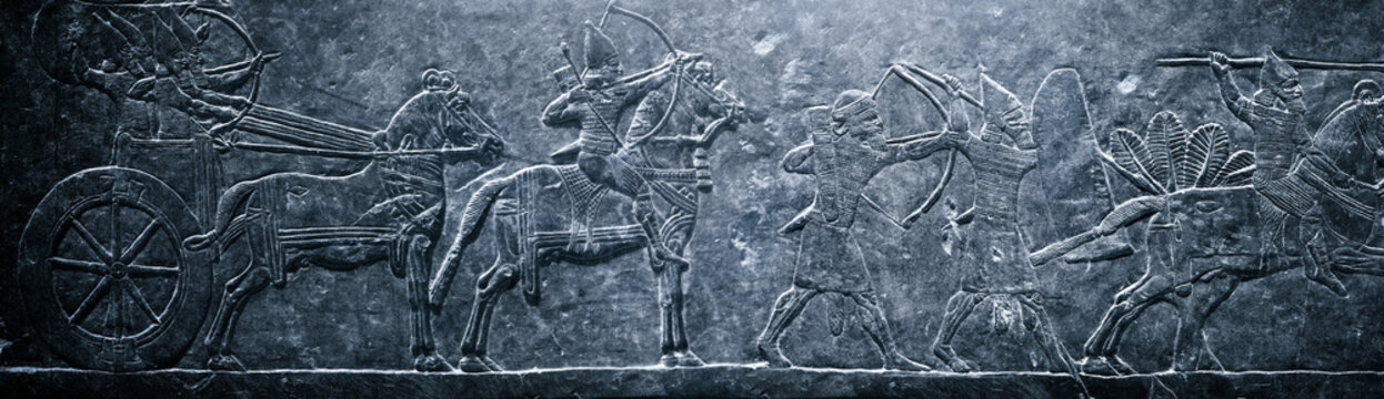 Assyrian relief on the wall. Historical and culturical background on the theme of civilizations of Assyria, Mesopotamia, Babylon, interfluve, Sumerian.