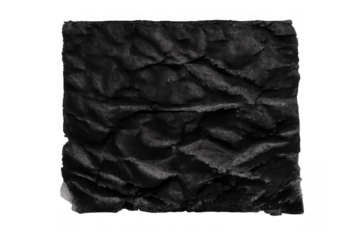 Black charcoal block with wavy, rough texture, representing abstract art, darkness, and energy