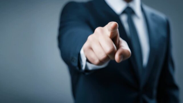A businessman in a suit pointing assertively at the viewer, conveying authority and engagement.