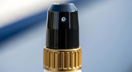 black and gold cylindrical object with ridged base