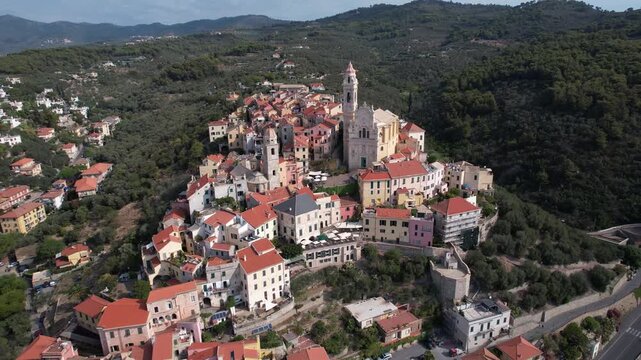 Aerial view of Cervo showing the church and colorful buildings cascading down to the coastline, a captivating blend of architecture and nature, Cervo, Liguria, Italy.