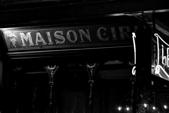Brussels, Belgium - October 14th 2017: Night view of the historic Maison Cirio tavern facade, captured in black and white, emphasizing classic signage, architecture, and timeless Brussels nightlife.