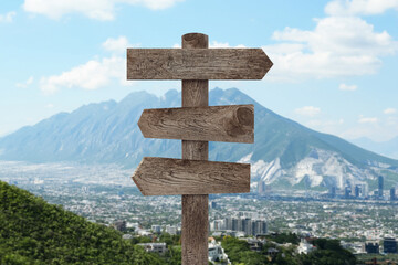 Wooden signpost with arrows pointing in different directions in mountains