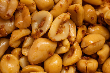 Roasted peanuts with savory spices, showcasing detailed texture and golden color.