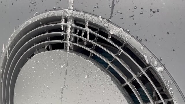 Frozen heat pump in winter, icicles