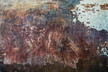 A badly damaged church fresco depicting a scene of hellfire