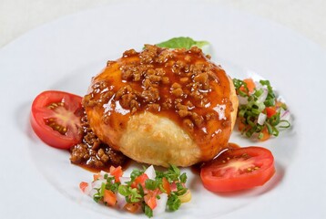 Delicious Indian Cuisine Dish with Spicy Meat and Tomato Garnish: Flavorful Plated Meal in Restaurant Presentation Close-Up Photography