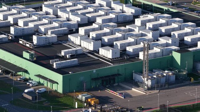 Aerial view of the AI Data Center showcasing a vast array of white modules atop a green structure, Middenmeer, Netherlands.